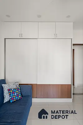 Modern wardrobe with frosty white and walnut brown laminate in bedroom of 2 BHK in Purva Palm Beach Hennur Bengaluru | Material Depot