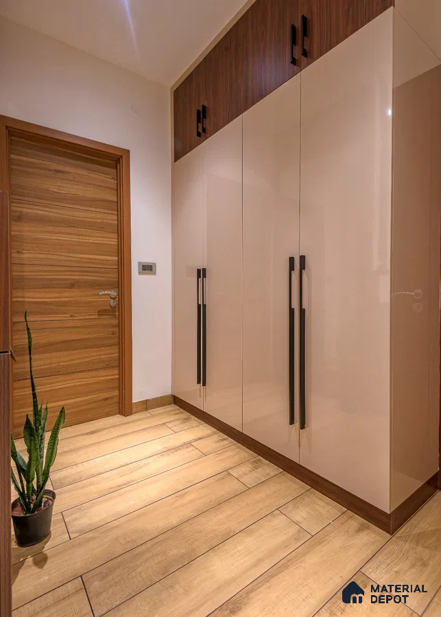 Modern wardrobe with glossy beige laminate shutters and walnut wood accents on wood-look floor tile | Material Depot
