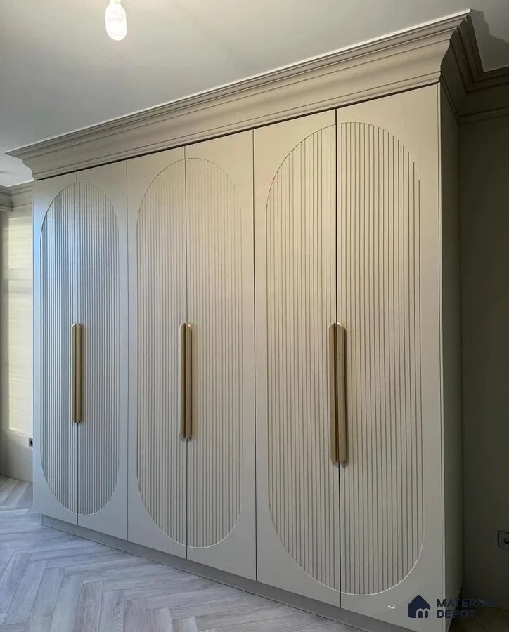 Modern wardrobe with ivory fluted laminate shutters and gold handles | Material Depot