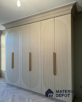 Modern wardrobe with ivory fluted laminate shutters and gold handles | Material Depot