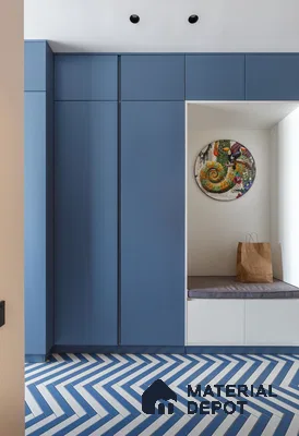 Modern wardrobe with matte blue laminate shutters and blue-and-white herringbone floor tiles | Material Depot