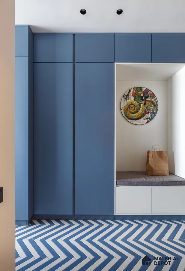 Modern wardrobe with matte blue laminate shutters and blue-and-white herringbone floor tiles | Material Depot