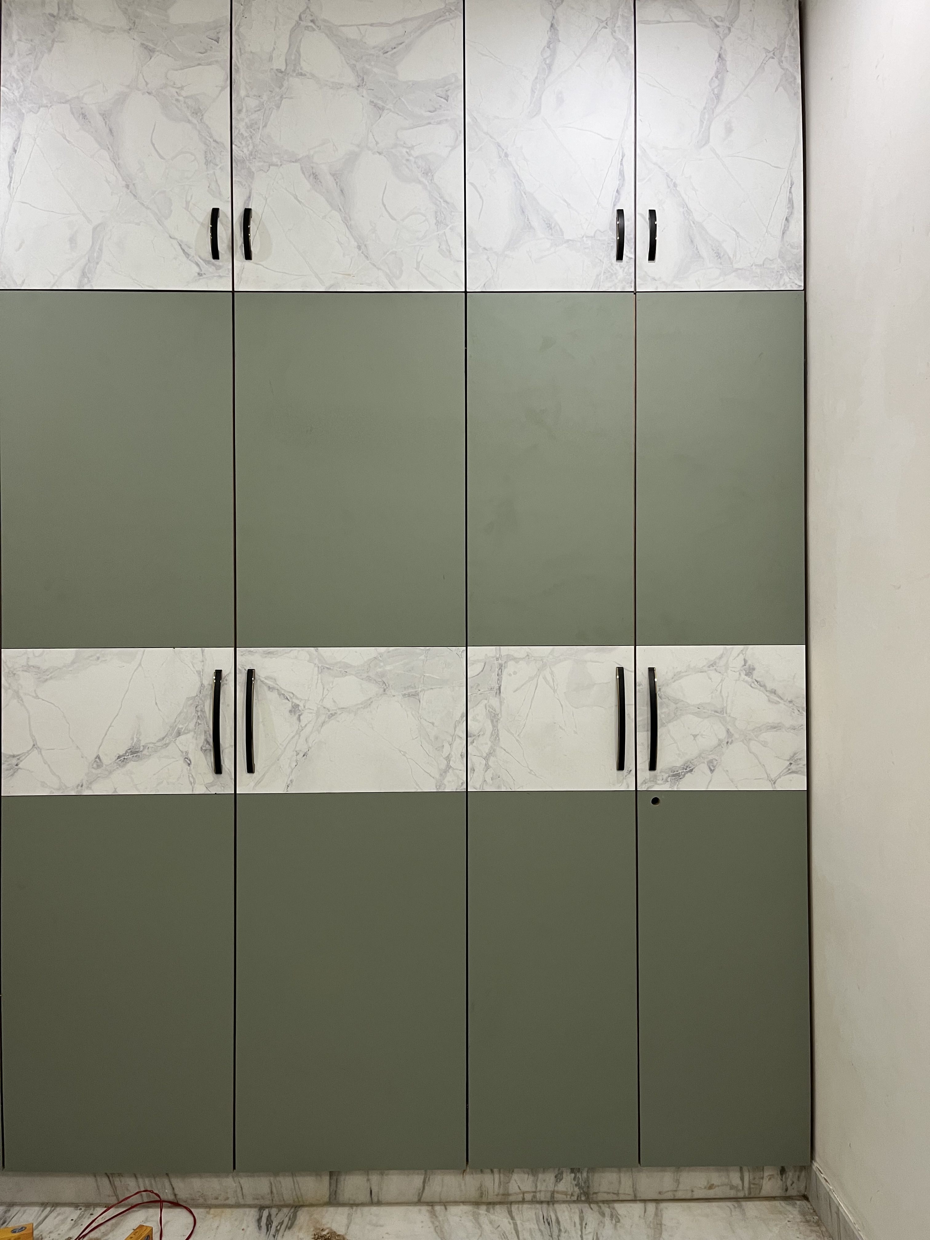Modern wardrobe with sage green solid laminate and white marble-look laminate shutters | Material Depot