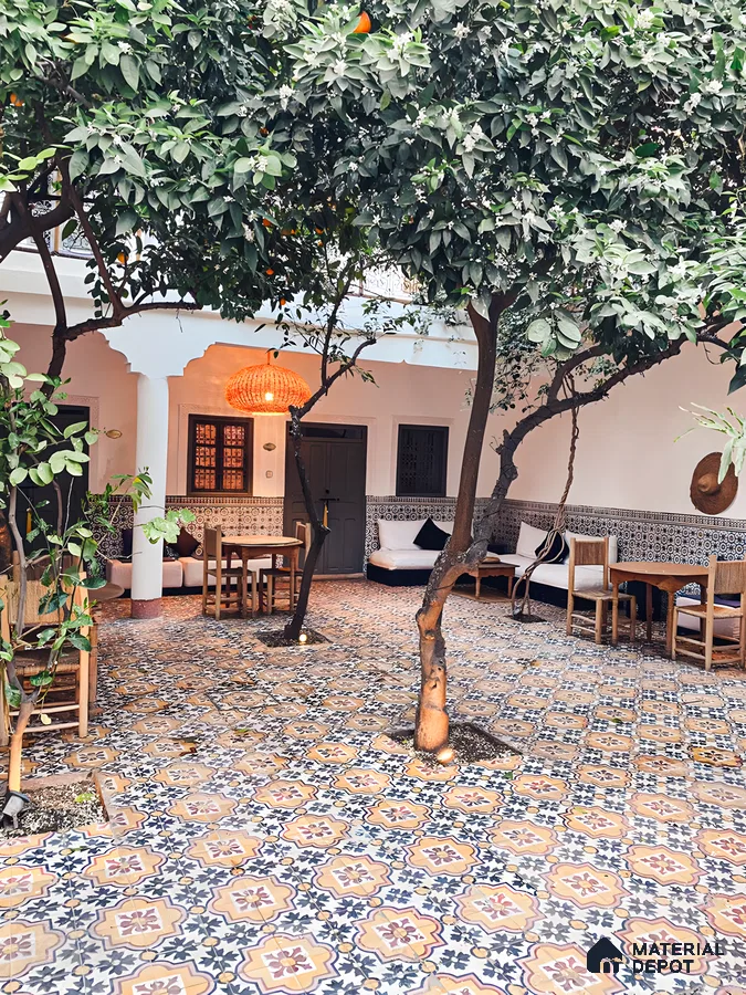 Moroccan-Inspired Courtyard with Patterned Tiles and Orange Tree | Material Depot