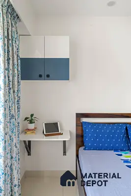Scandinavian bedroom with blue and white laminate cabinet, wooden bed, and patterned blue curtains of 2 BHK in Purva Palm Beach Hennur Bengaluru | Material Depot
