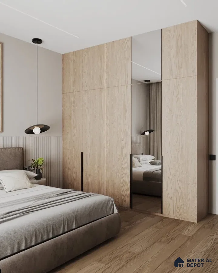 Scandinavian bedroom with light oak wardrobe, mirrored shutters, and wooden flooring | Material Depot
