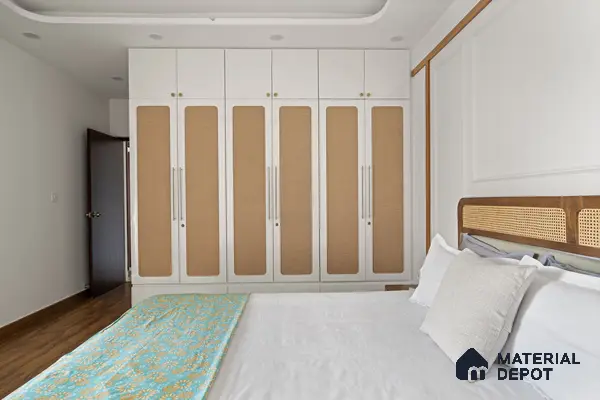 Scandinavian bedroom with white and beige wardrobe, cane headboard, and wooden flooring of 2 BHK in Purva Palm Beach Hennur Bengaluru | Material Depot