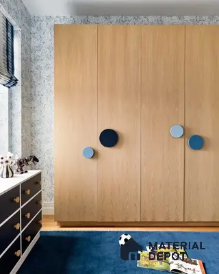 Scandinavian kids room with light oak wardrobe, blue accent handles, and blue patterned wallpaper | Material Depot