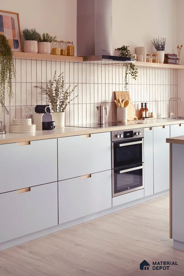 Scandinavian kitchen with frosty white laminate cabinets, oak wood accents, and vertical white subway backsplash tiles in Bengaluru | Material Depot