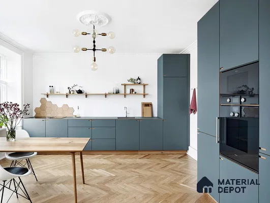 Scandinavian kitchen with matte blue laminate cabinets and herringbone oak wooden flooring in Bengaluru | Material Depot