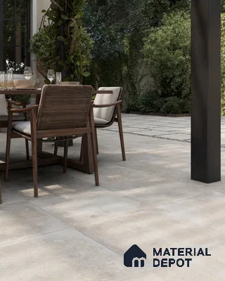 Serene Outdoor Patio with Grey Porcelain Tile Flooring and Lush Greenery | Material Depot
