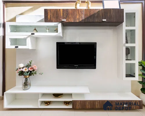 Foyer with a laminate finish TV unit, large TV fixed on the panel, adorned with a floral vase, and enhanced by wooden detailing.