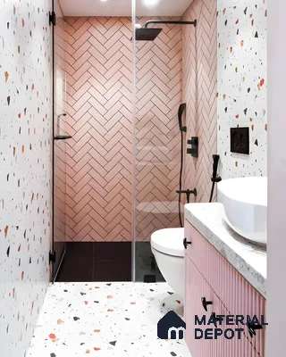 Soft Pink Herringbone Tiles with Bold Terrazzo Accents in a Modern Bathroom | Material Depot
