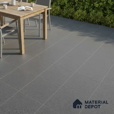 Minimalist outdoor space with grey matte floor tiles and natural wood dining table
