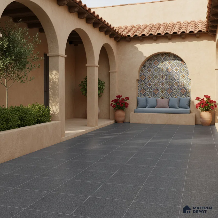 Mediterranean outdoor courtyard with patterned moroccan wall tiles and charcoal grey floor tiles