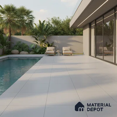 Modern outdoor poolside with large format light grey matte floor tiles and minimalist landscaping