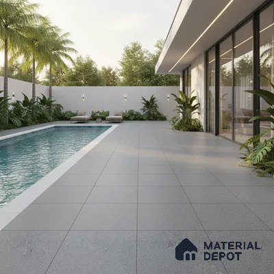 Modern outdoor poolside with large format grey matte floor tiles and minimalist landscaping