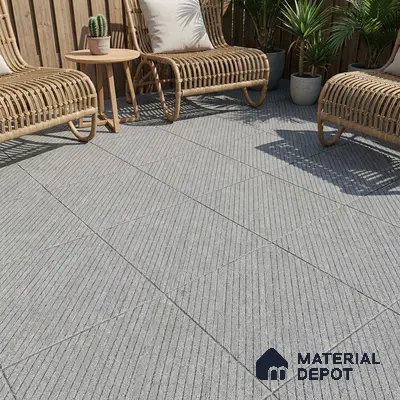 Scandinavian outdoor space with grey textured floor tiles and rattan furniture