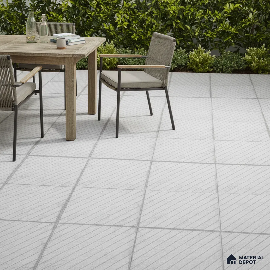 Minimalist outdoor patio with light grey diagonal line floor tiles and natural wood dining set