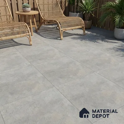 Scandinavian outdoor patio with grey cement-look floor tiles and natural rattan lounge chairs