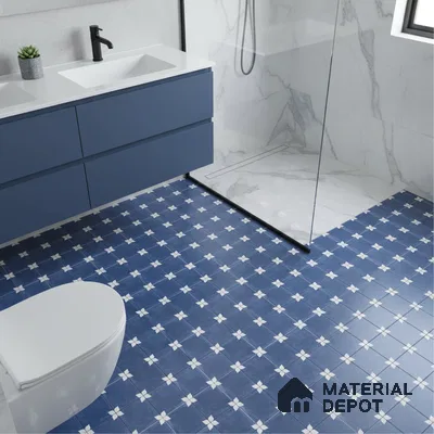 Modern bathroom with blue patterned floor tiles, white marble wall tiles, and matte blue vanity laminate