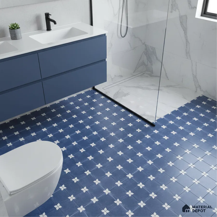 Modern bathroom with blue patterned floor tiles, white marble wall tiles, and matte blue vanity laminate