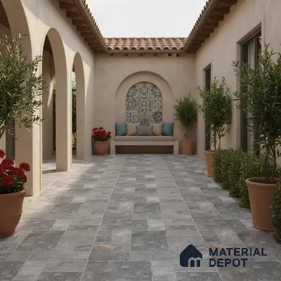 Mediterranean outdoor courtyard with patterned mosaic tile accent and stone-look floor tiles