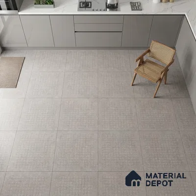 Minimalist kitchen with grey matte laminate cabinets, white marble-look quartz countertop, and patterned light grey floor tiles