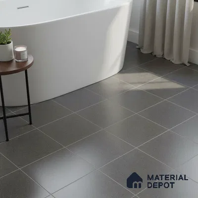 Minimalist bathroom with matte charcoal grey floor tiles and freestanding tub