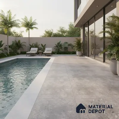 Modern outdoor poolside with grey stone-look floor tiles and tropical landscaping