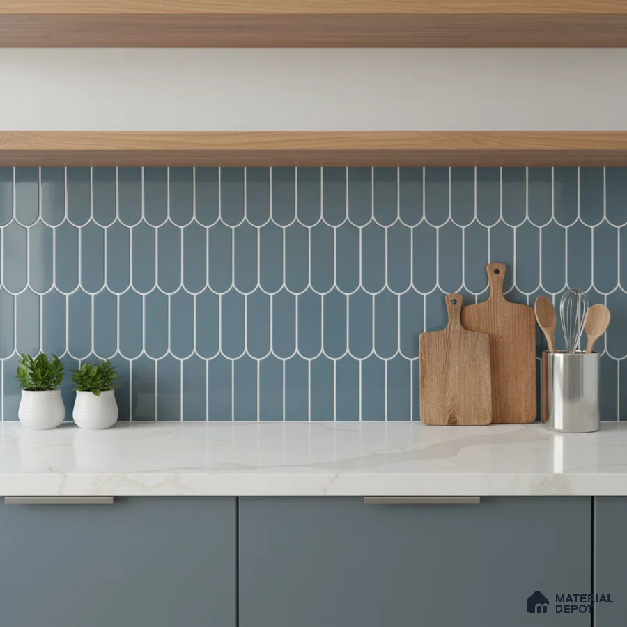 Modern kitchen with blue scallop backsplash tile, white marble countertop, and matte blue laminate cabinets