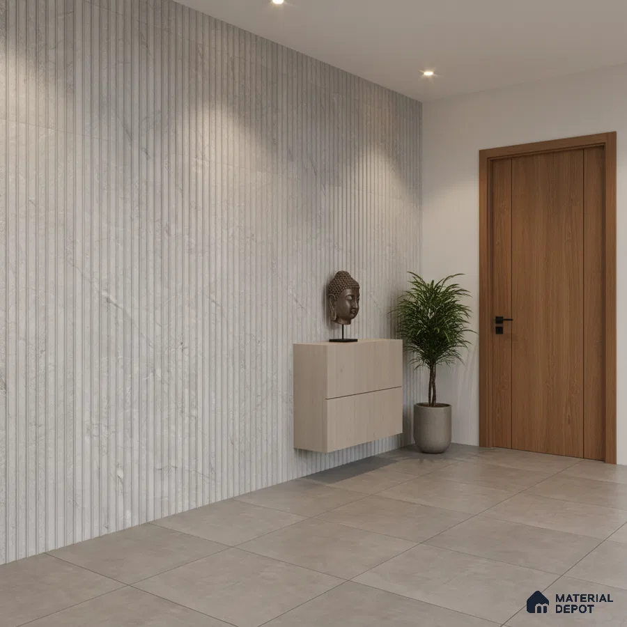 Minimalist foyer with fluted marble wall panels, light wood laminate console, and large grey floor tiles