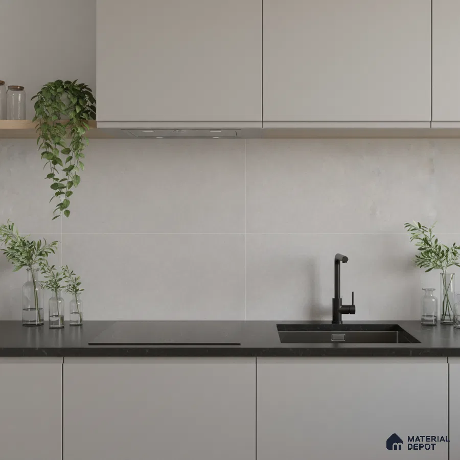 Minimalist kitchen with frosty white laminate cabinets, black quartz countertop, and light grey stone backsplash tile