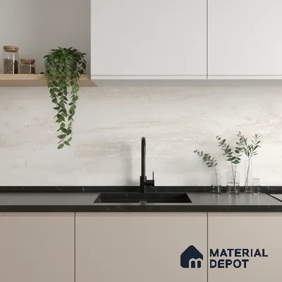 Minimalist kitchen with beige matte laminate, black marble countertop, and travertine-look backsplash tile