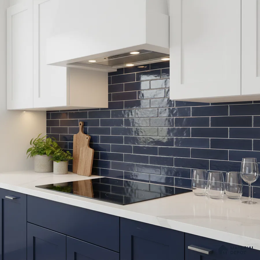Modern kitchen with navy blue subway tile backsplash, white quartz countertop, and dual tone laminate cabinets