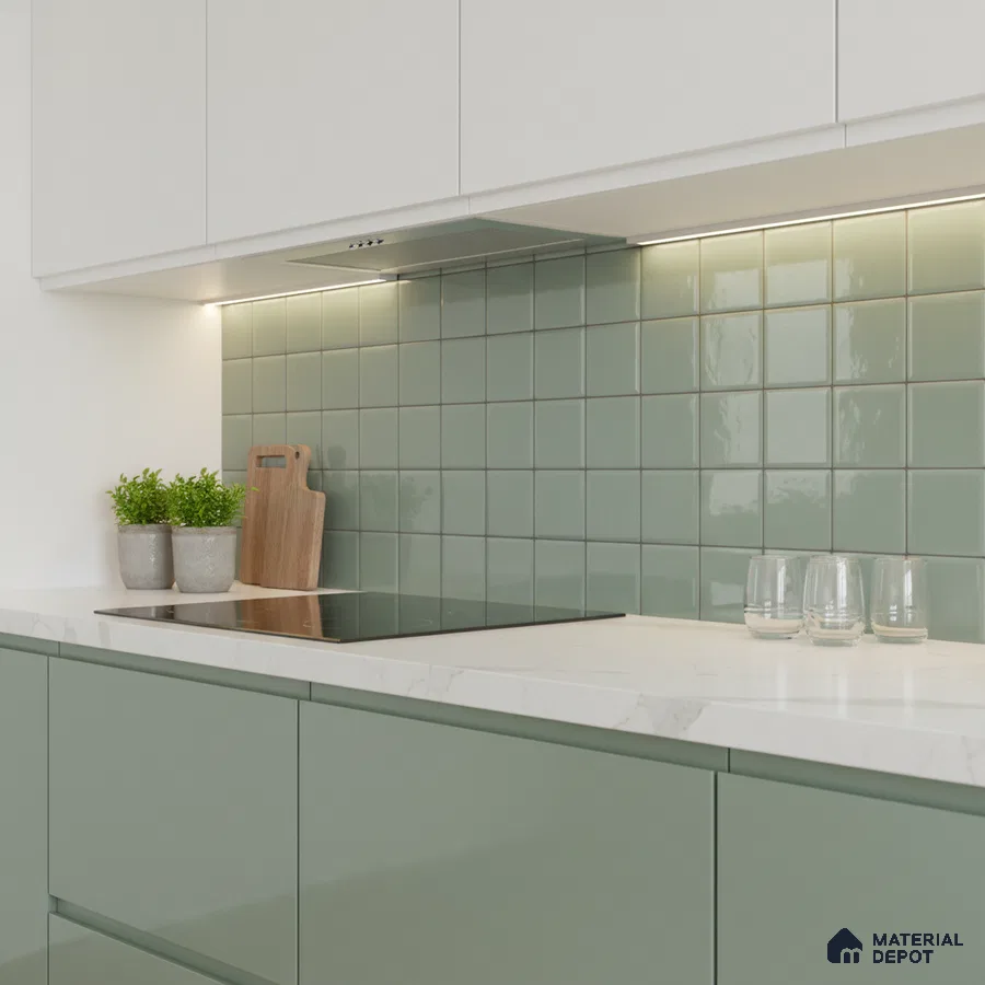 Modern kitchen with sage green laminate, white marble-look quartz countertop, and sage green square backsplash tiles