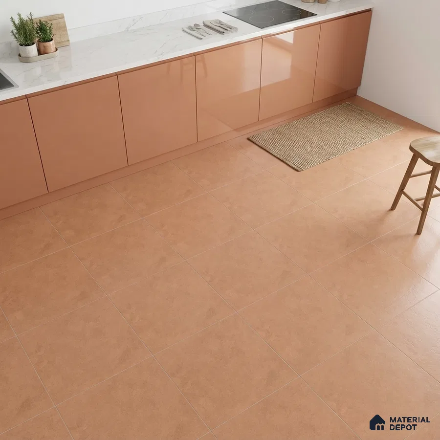 Modern kitchen with terracotta floor tiles and glossy peach laminate cabinets with white marble countertop
