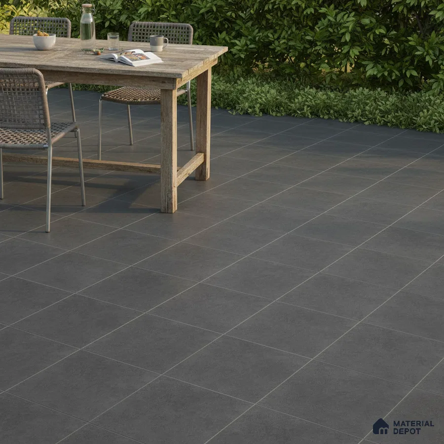 Minimalist outdoor space with charcoal grey stone-look floor tiles and rustic wooden dining set