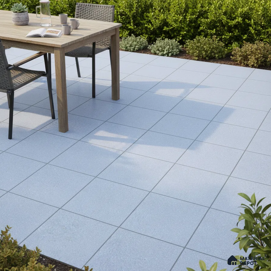 Minimalist outdoor patio with light grey square floor tiles and wooden dining set