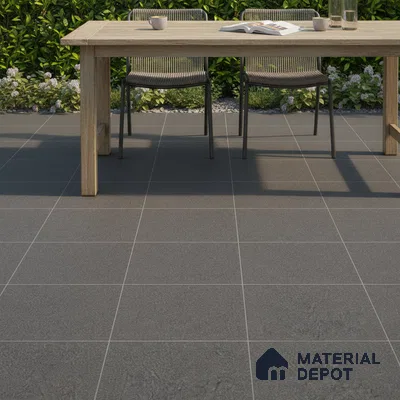 Minimalist outdoor space with matte charcoal grey stone floor tiles and natural wood dining table