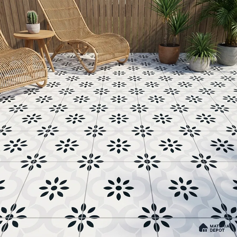 Scandinavian outdoor patio with black-and-white floral patterned floor tiles and rattan furniture