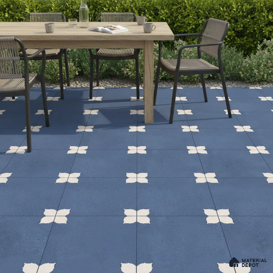 Modern outdoor dining with blue geometric patterned floor tiles and natural wood table