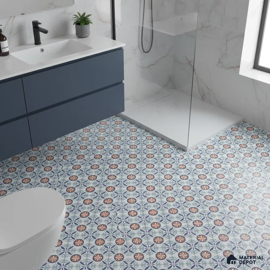 Modern bathroom with blue vanity, marble wall tiles, and blue geometric patterned floor tiles