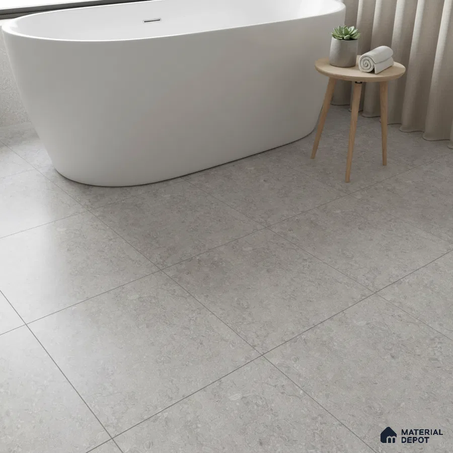 Minimalist bathroom with light grey stone-look floor tiles and freestanding tub