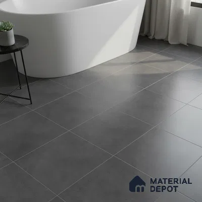 Minimalist bathroom with matte charcoal grey floor tiles and freestanding tub