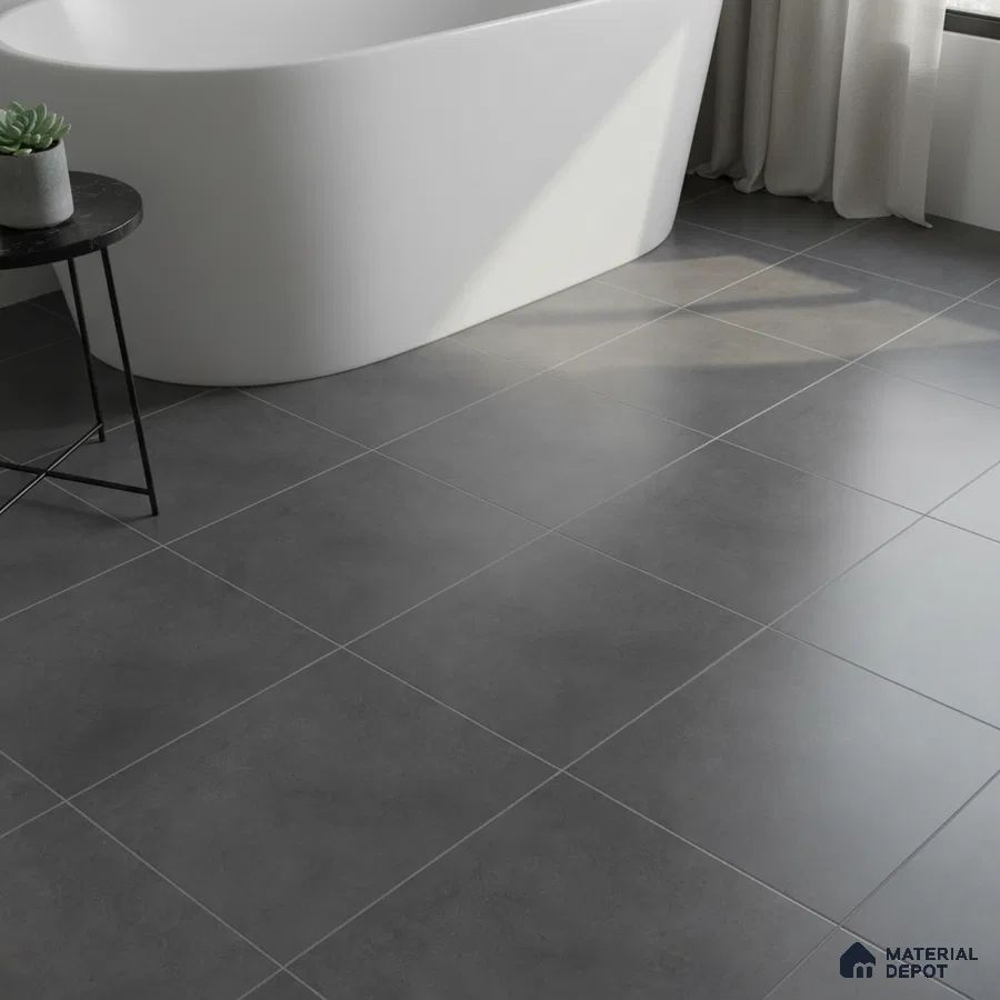 Minimalist bathroom with matte charcoal grey floor tiles and freestanding tub