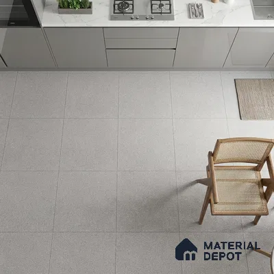 Modern kitchen with grey matte laminate cabinets, white marble-look quartz countertop, and light grey stone floor tiles