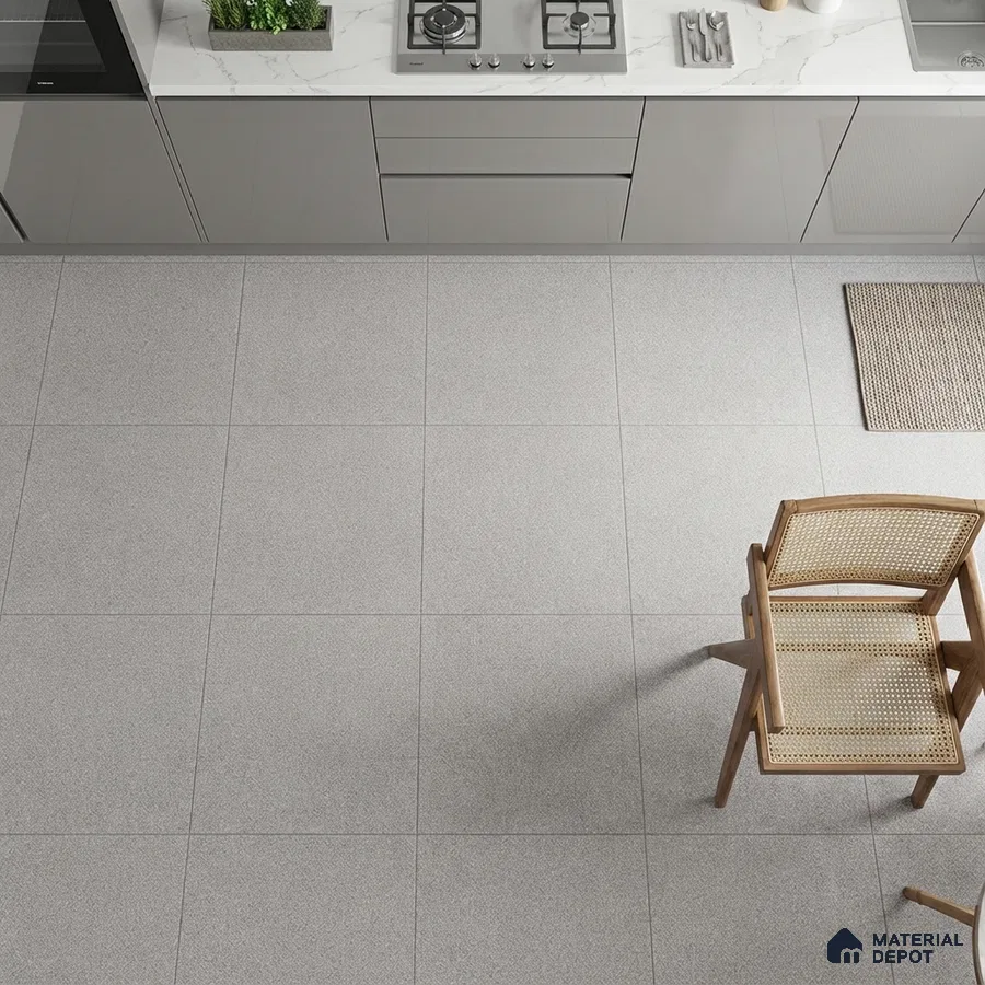 Modern kitchen with grey matte laminate cabinets, white marble-look quartz countertop, and light grey stone floor tiles