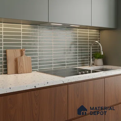 Scandinavian kitchen with sage green cabinets, terrazzo countertop, and horizontal green subway backsplash tile