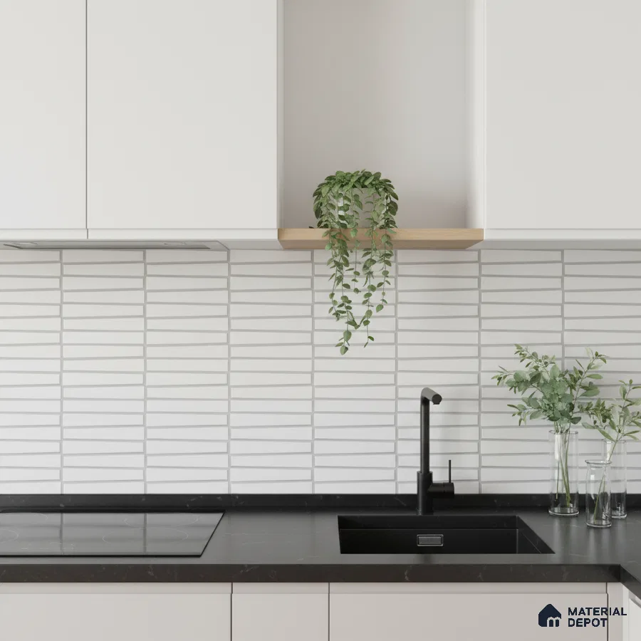 Minimalist kitchen with frosty white laminate cabinets, black quartz countertop, and white geometric backsplash tiles